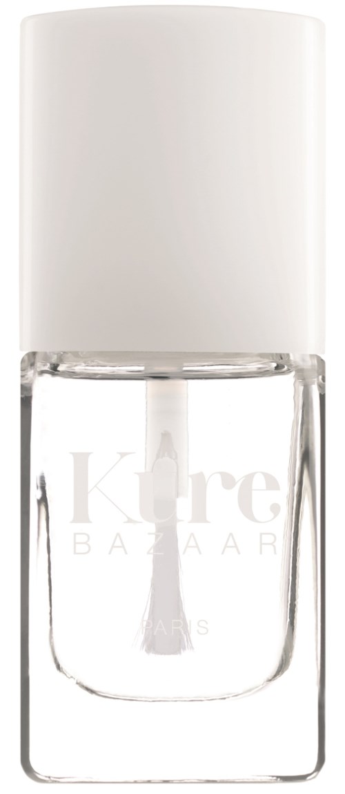 Eine klare Glasflasche mit Nagellack, weißer Deckel, beschriftet mit 'Kure BAZAAR'.