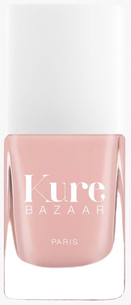 Eine pinke Nagellackflasche mit weißem Deckel und der Aufschrift 'Kure Bazaar Paris'.