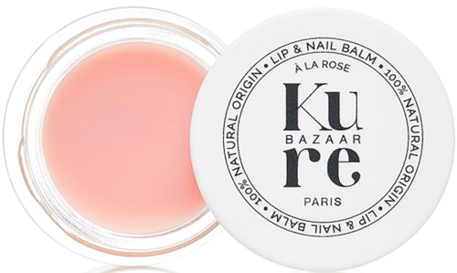A small round container with pink lip and nail balm inside, labeled with "Core Bazaar" and details about ingredients.