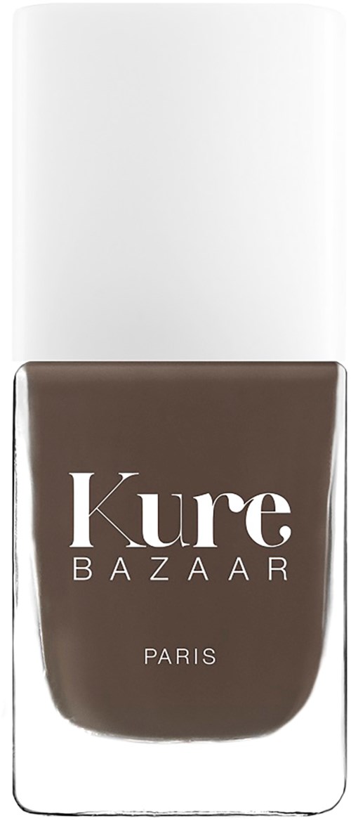 Eine braune Nagellackflasche mit weißem Text 'Kure BAZAAR PARIS' und weißem Deckel.