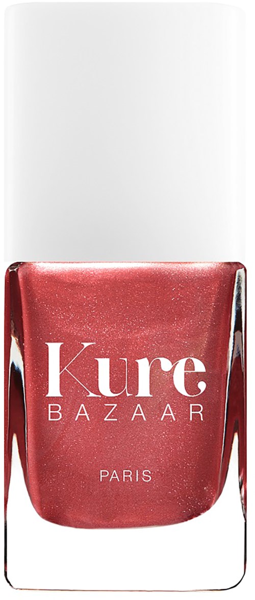 Ein pinkfarbener Nagellackflasche mit weißem Deckel, beschriftet 'Kure BAZAAR PARIS.'