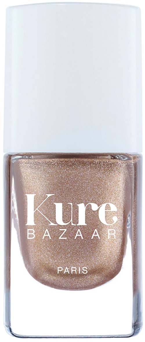 Ein Nagellackflasche mit glänzend beiger Farbe und weißem Deckel, Beschriftung 'Kure BAZAAR PARIS.'