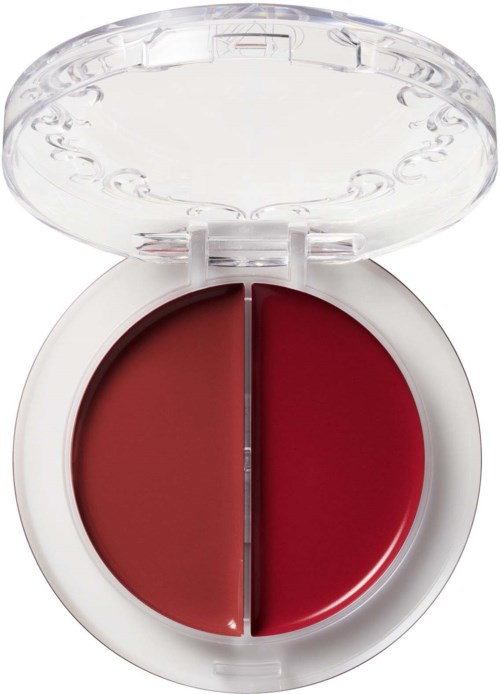 Een kleine ronde container met twee tinten rood makeup of pigment, afgesloten met een doorzichtig deksel.