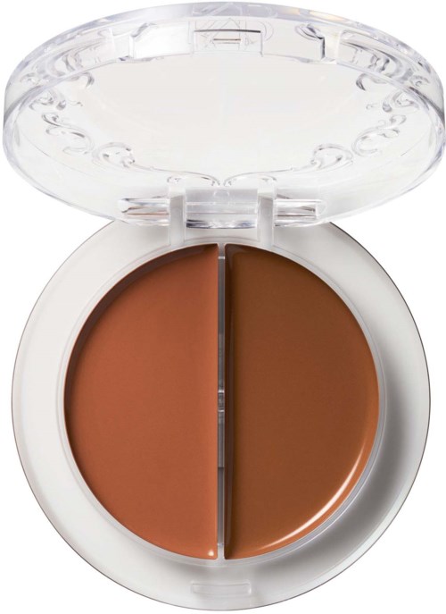 Een compact met twee tinten bruin foundation of concealer, beschermd door een doorzichtige deksel.