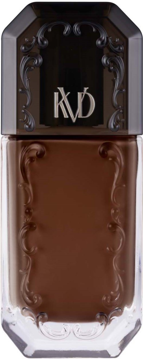 Een lange, elegante bruin vloeistoffles met een zwarte dop met decoratieve details en de letters KVD.