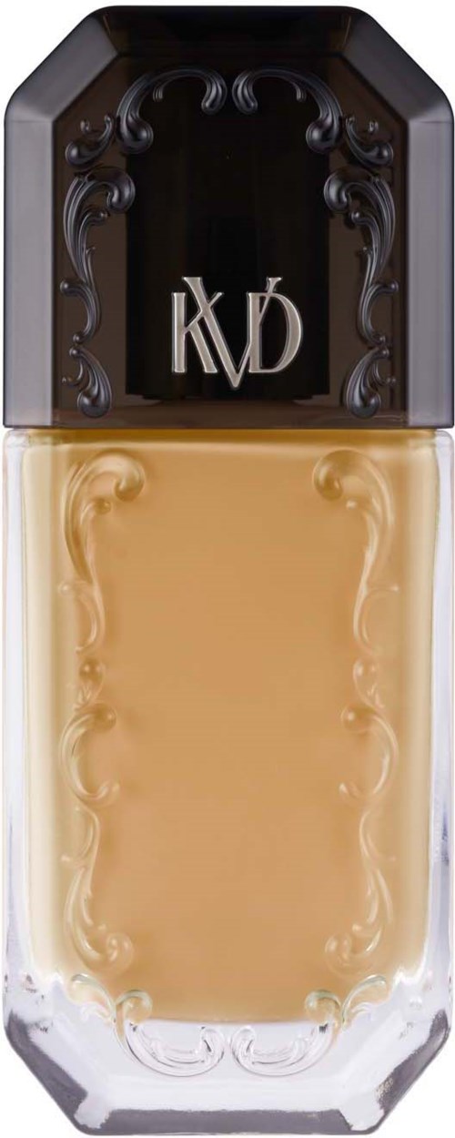 En flaska med svart lock och genomskinlig kropp som visar beige vätska inuti. Locket har en dekorativ svart design.