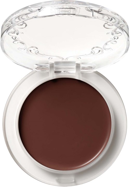 En rund brun makeup-produkt i ett vitt skal med ett tydligt lock. Skalet öppnas för att visa makeuppen.