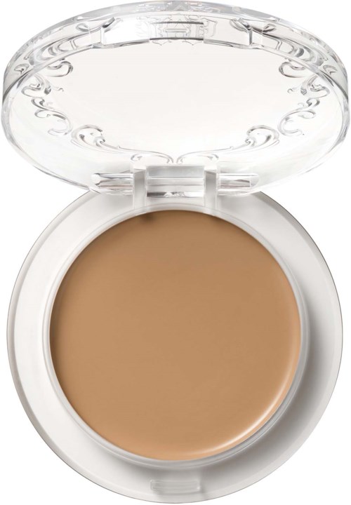 En liten burk med beige puder och ett tydligt lock som är öppet.