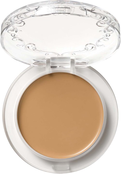 En liten dosa med ljusbrun eller beige kräm inuti och ett genomskinligt lock som öppnas.