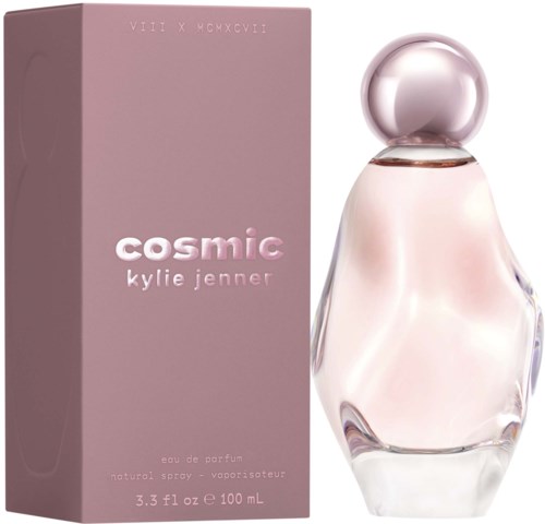 A pink box with pink and white text and a glass perfume bottle with a spherical cap.