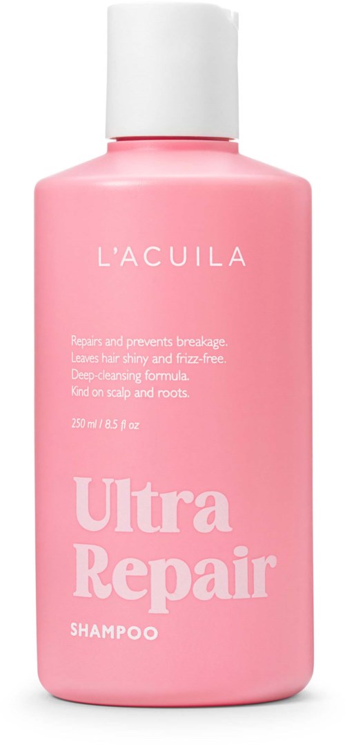 Roze fles met shampoo getiteld 'L'ACUILA Ultra Repair' dat haar herstelt en versterkt. Het voorkomt breuk en geeft glans.