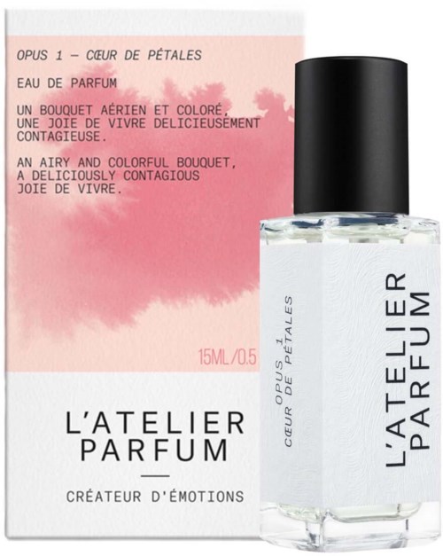 A perfume bottle with a black cap and a pink and white label. The label has text describing the fragrance as lively and colorful.