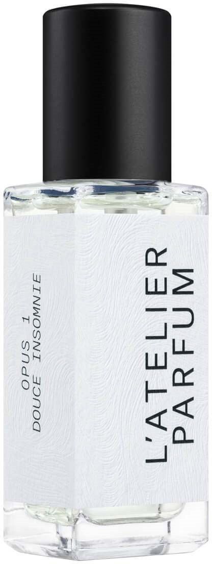 A clear perfume bottle with a black cap and a white label that says 'L'Atelier Parfum' and 'Opus 1Douce Tinosomite.'