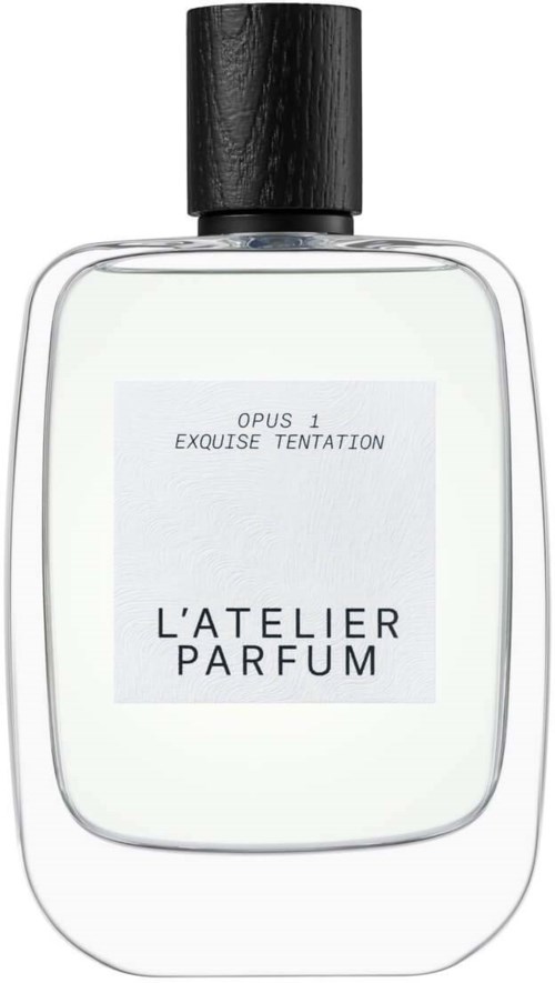 A clear perfume bottle with a black cap and a white label showing the scent name and brand.