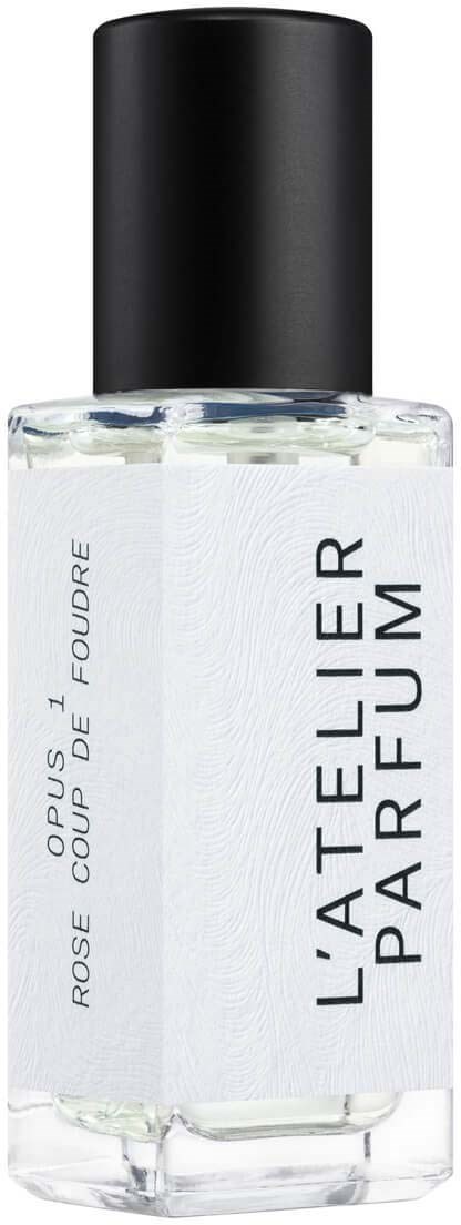 A clear perfume bottle with a black cap, labeled 'L'Atelier Parfumeur' and 'Rose Coup De Foudre' in elegant font.