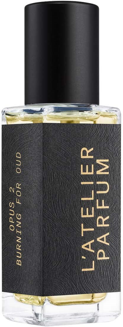 A clear bottle with a black label and cap, labeled 'L'ATELIER PARFUM' and 'OPUS 2 BURNTING FOR OUR' with yellow liquid inside.