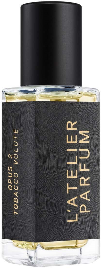A perfume bottle with a black cap and a label saying "L'ATELIER PARFUM" and "TOBACCO VOLUTÉ".