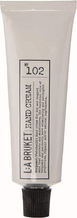 Eine weiße Tube mit schwarzem Deckel, beschriftet mit 'La Bruzet Hand Cream No 102' und Beschreibungstext.