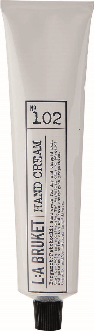 Ein weißes Röhrchen mit der Bezeichnung L'ABRUQUET HAND CREAM und schwarzem Deckel.