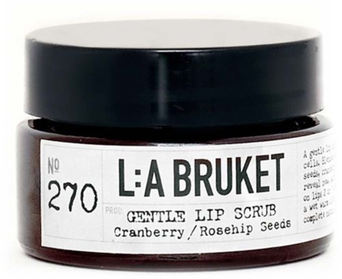 Ein Glas mit dem Etikett L:A BRUKET, sanftes Lip Scrub mit Cranberry- und Hagebuttenkernen, schwarzer Deckel, weißes Etikett.