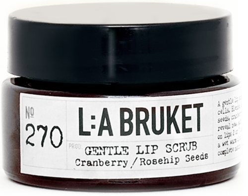 Ein Glas mit Lippenpeeling, Cranberry und Hagebuttenkernen, gekennzeichnet als sanft mit schwarzem Deckel.