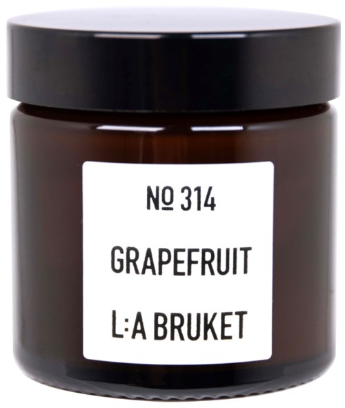Ein kleiner Behälter mit schwarzem Deckel, beschriftet 'Grapefruit' und 'L:A Bruket', wahrscheinlich ein Duftprodukt.