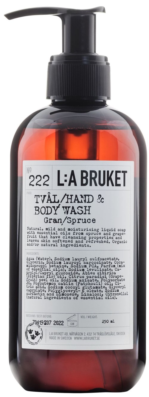 Een bruine fles met een zwarte pomp met label 'L:A BRUKET' voor hand- en bodywash, bevat vloeibare zeep.