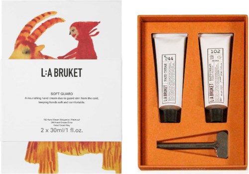 Kaksi La Bruket ihonhoitotuotetta oranssissa laatikossa pienen applicaattorin kanssa.