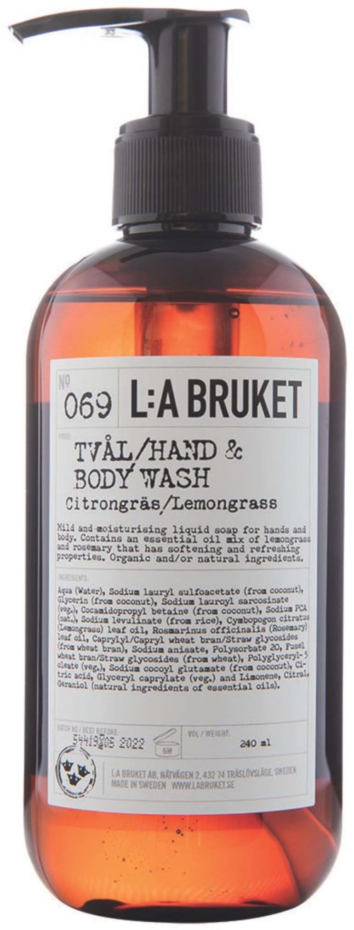 Eine klare Pumpflasche mit Hand- und Körperspülung, weißen Etikett und schwarzem Text.