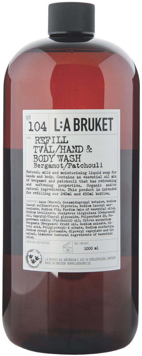 Eine rote Flasche mit schwarzem Deckel, gekennzeichnet als Nachfüllgel/Hand- und Körperwäsche mit Bergamotte und Patchouli.