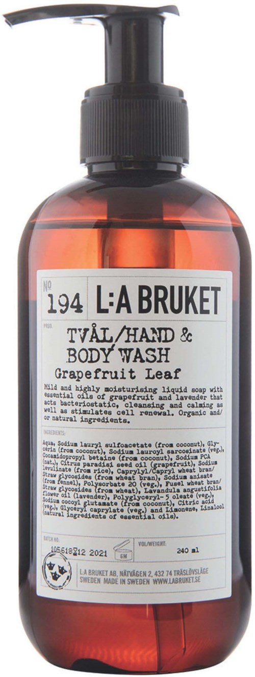 Een bruin pompflacon met witte label voor Grapefruit Leaf Body Wash, bevat vloeibare zeep.