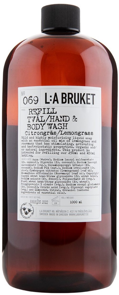 A brown plastic bottle with a black cap, containing lemon-scented hand and body wash by L:A Bruket.