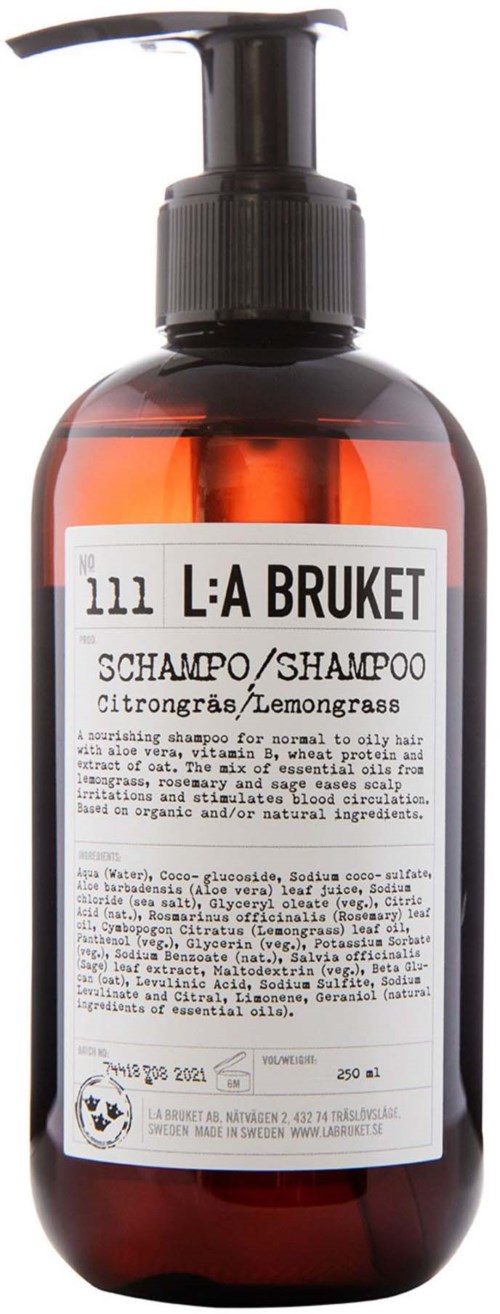 Eine Flasche L:A Bruket Shampoo mit Zitronengras, Pumpe und weißem Etikett mit Inhaltsstoffen.