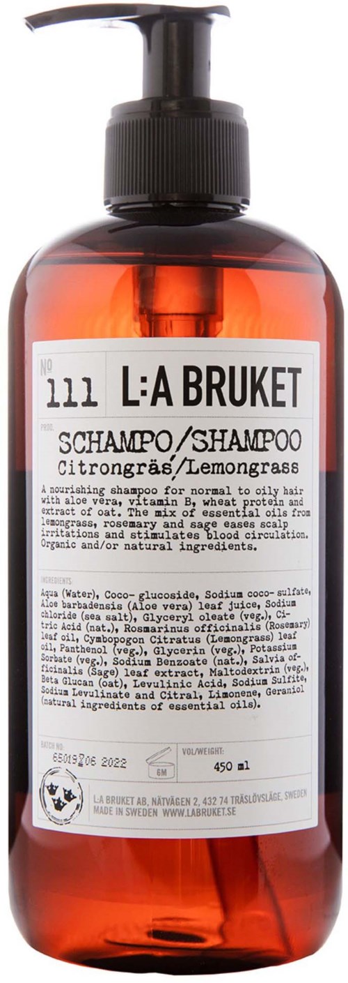 Eine braune Shampoo-Flasche mit schwarzer Pumpe, weißem Etikett mit Text und transparentem Deckel.