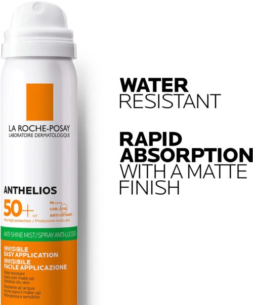 A white sunscreen spray bottle with orange and black text highlighting water resistance and fast absorption.