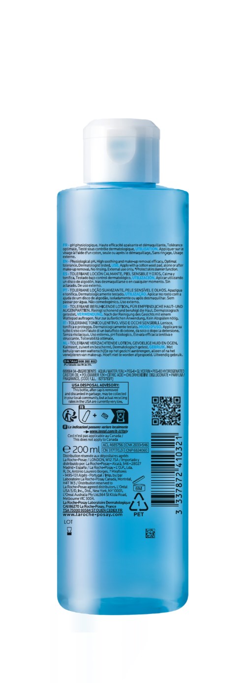 Een blauwe fles met een witte dop, met veel tekst en symbolen, waarschijnlijk een cosmetisch of verzorgingsproduct.