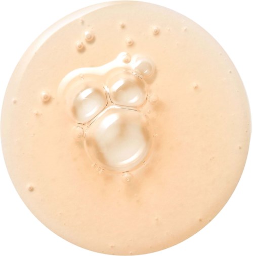 A creamy drink with bubbles and foam on surface, viewed from above.
