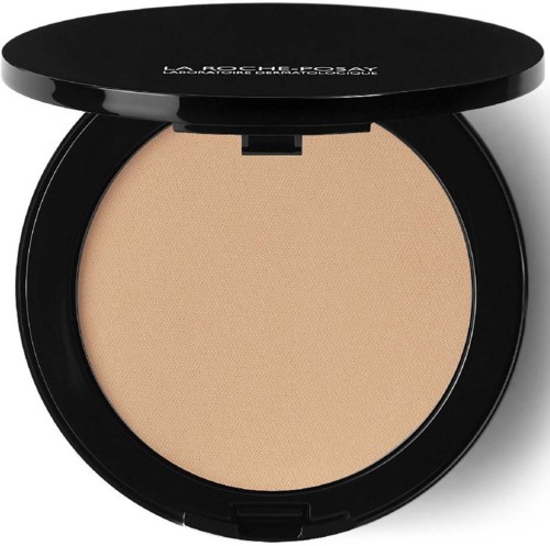 Eine runde Make-up-Box mit beige Puder und schwarzem Deckel.