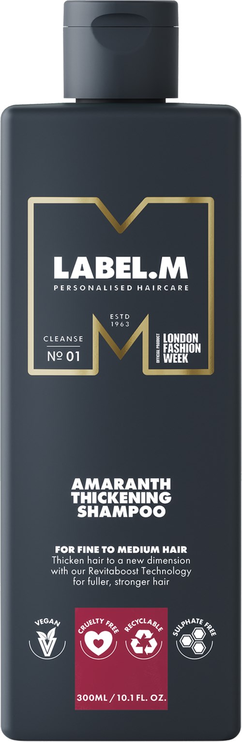 En mörkgrå flaska med etiketten 'Amaranth Thickening Shampoo' i guld och vitt, märke 'LABEL.M'.