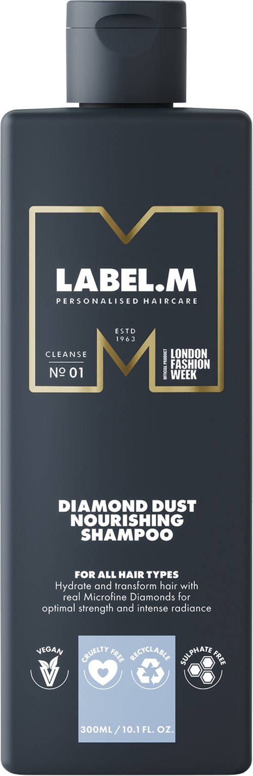 En mörk flaska med en guldfärgad och vit etikett för Label.M schampo, med fokus på diamantdamm närande ingredienser och hårvård.
