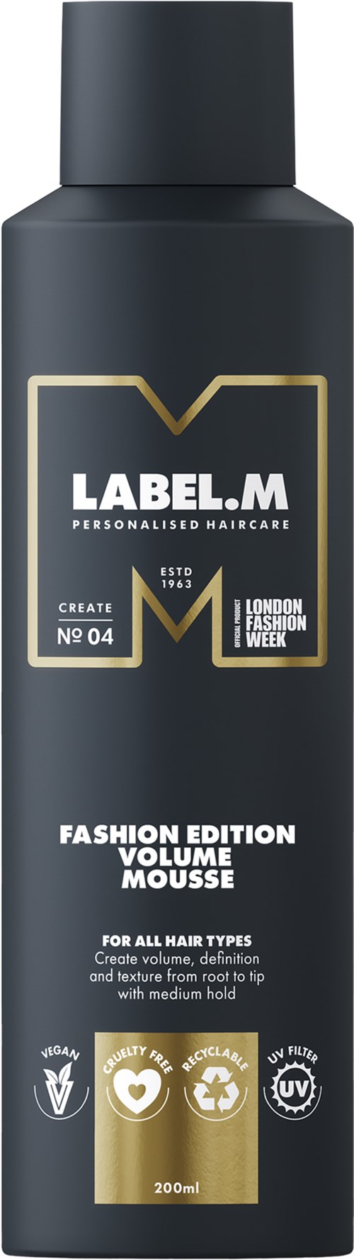 En svart flaska med hårmousse med vit och guld text, märkt Label.M Fashion Edition Volume Mousse.