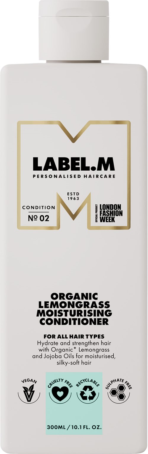 En vit flaska märkt 'LABEL.M' med en guldig och svart logga. Det är ett organiskt citrongrassbalsam för alla hårtyper.