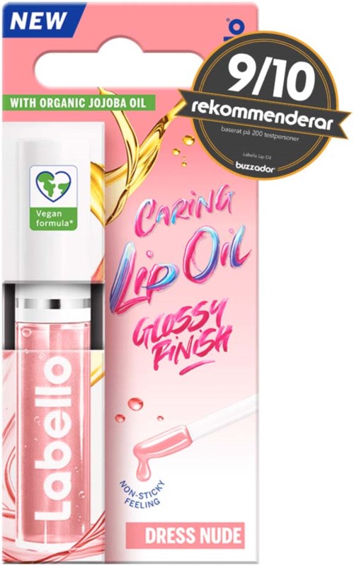 Lippenbalsemtube met roze verpakking, gemarkeerd 'Dressing Nude,' en een zwarte badge met 9/10. Bevat organische jojoba-olie.