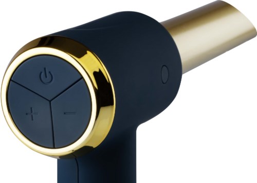 Een klein elektronisch apparaat met knoppen voor aan/uit, volume omhoog, volume omlaag en een ronde gouden rand.