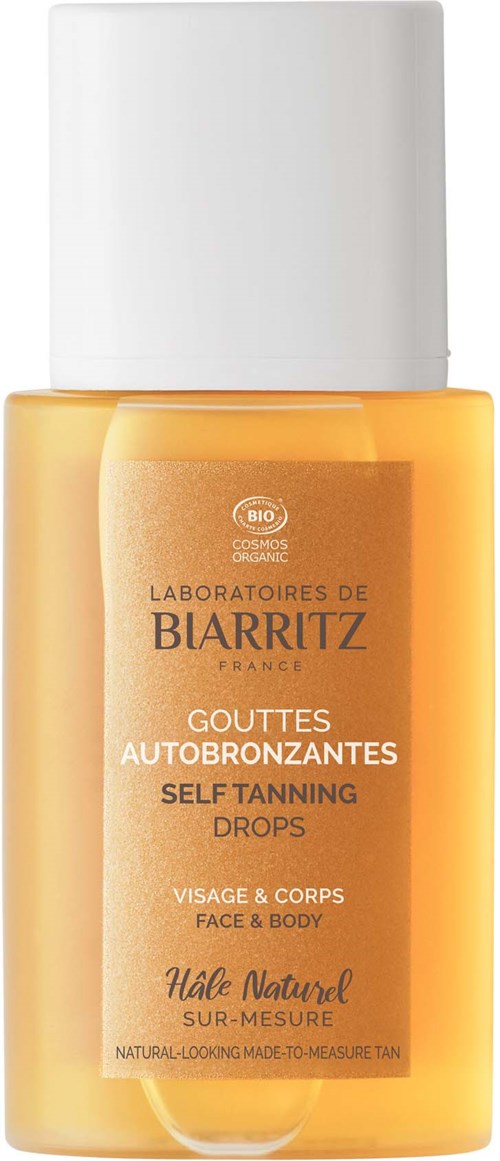 Gele zelfbruiningsdruppels in een klein flesje met witte dop, voor gezicht en lichaam.