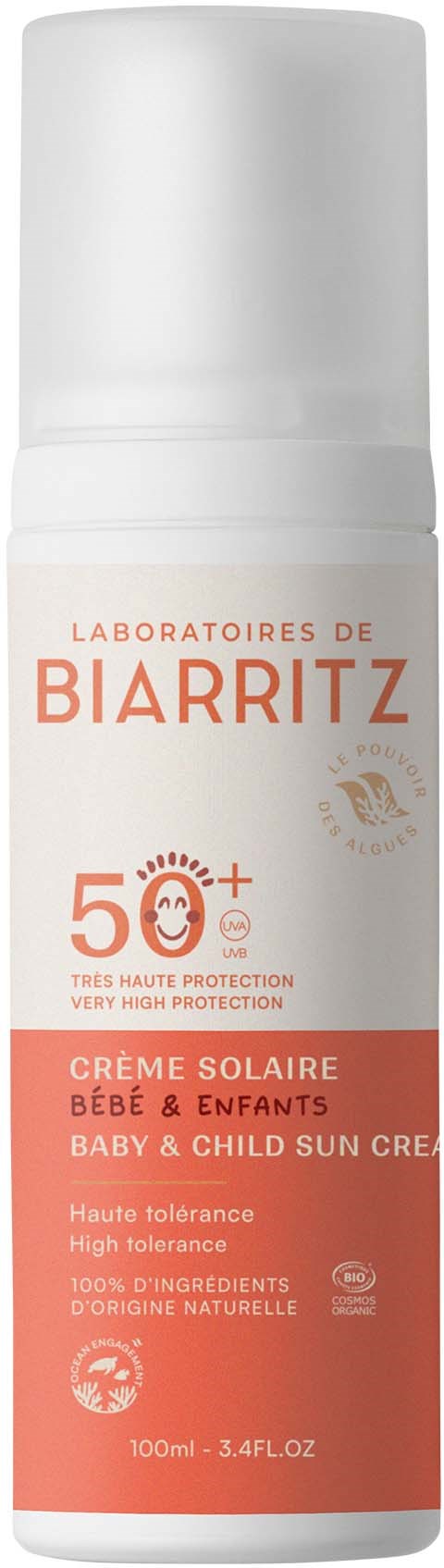 A white and orange sun protection cream bottle for babies and children with SPF 50+. Text in French and English on the label.
