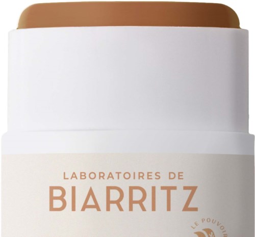 Een witte pot met bruin inhoud en een label dat zegt 'Laboratoires de Biarritz'.