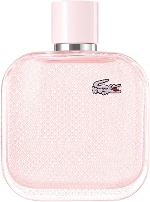 Roze parfumfles met een kleine krokodillesticker. Ronde vorm en eenvoudig ontwerp. Dop is lichtroze.