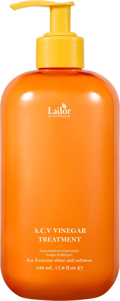 Orange flaska med pump märkt Lador A.C.V Vinägerbehandling för hårvård.
