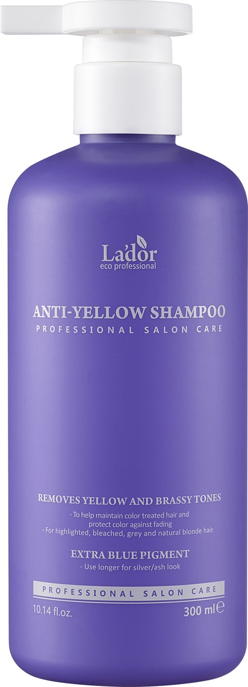 En lila flaska med pump. Den är märkt 'Lador Anti-Yellow Shampoo' för att ta bort gula och koppriga toner.